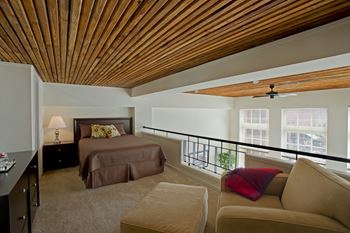 A bedroom with a bed and a balcony